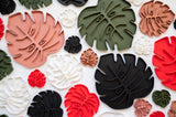 Sausr Monstera leaf shaped plant coaster for all size of houseplants red green white black terracotta colors against white background